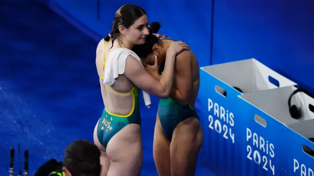 A tearful Annabelle Smith being consoled by Australia team-mate Maddison Keeney