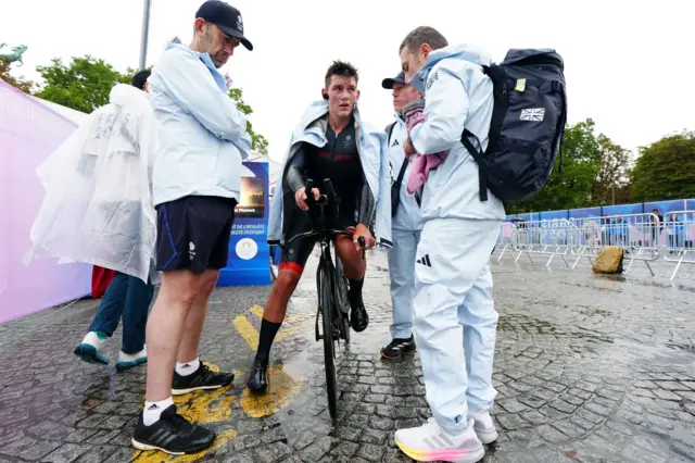 Josh Tarling speaks to his coaches after the race