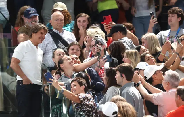 Tom Cruise at the Bercy Arena posing for photos with fans