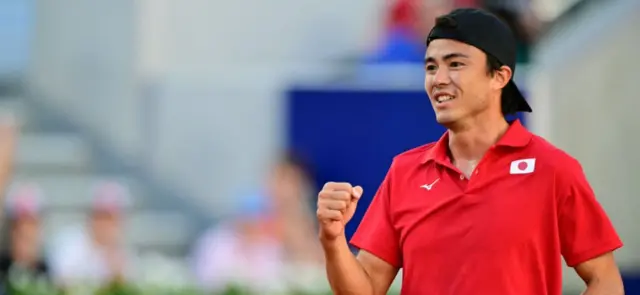 Japan's Taro Daniel playing with Japan's Kei Nishikori, reacts during their men's doubles first round tennis match against Britain's Andy Murray and Britain's Daniel Evans