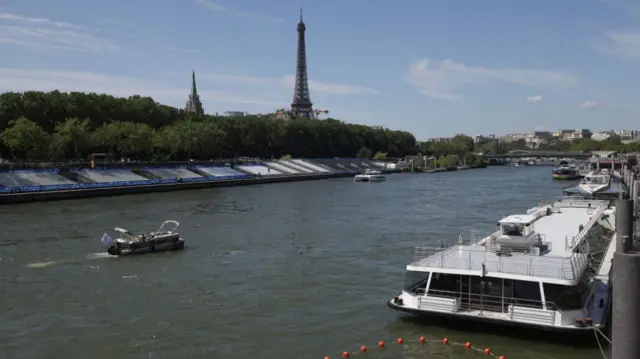 Boats are navigated on the Seine river with Eiffel Tower in background