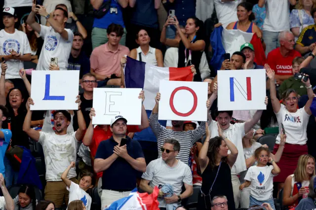 French fans hold signs spelling out 'Leon'