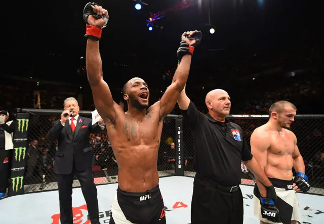 Leon Edwards celebrates being announced the winner in a UFC fight