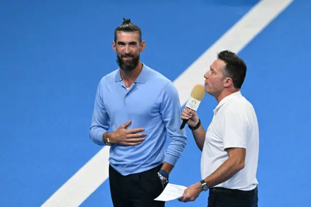 Michael Phelps conducts an interview poolside