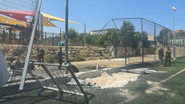 A crater can be seen in the football pitch at Majdal Shams