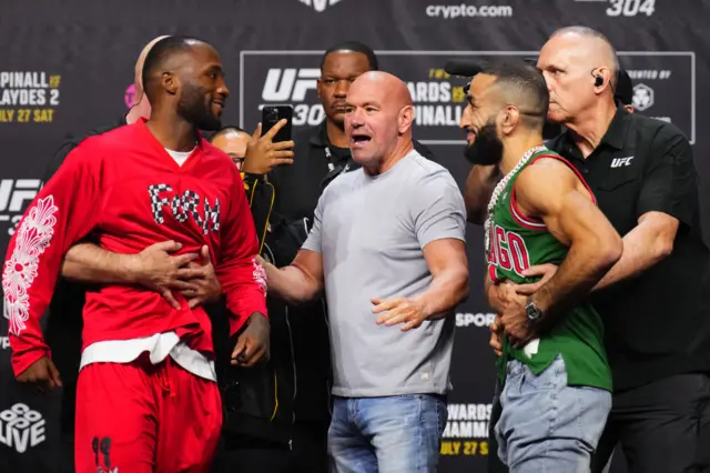 Leon Edwards and Belal Muhammad are held back as they come face-to-face