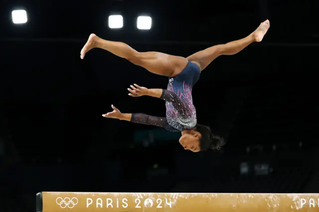 Simon Biles upside down on the Beam