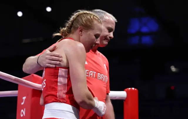 Rosie Eccles is consoled by her coach after losing on split decision