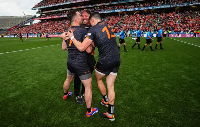 Aidan Forker, Rory Grugan and Ciaran McKeever embrace after the semi-final