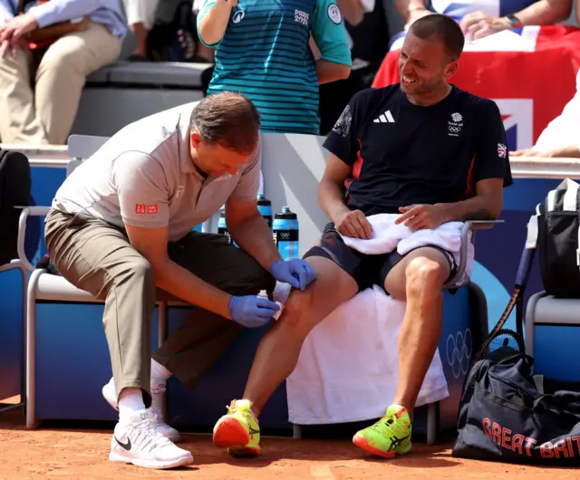 Dan Evans gets tended to by a physio