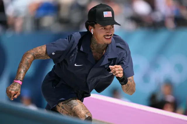 Huston smiles as he skates during the preliminaries