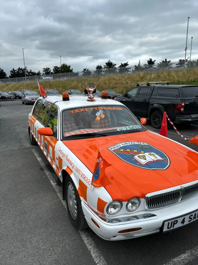 Orange car with Armagh crest