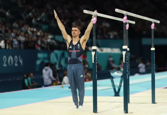 Whitlock poses after his high bars routine