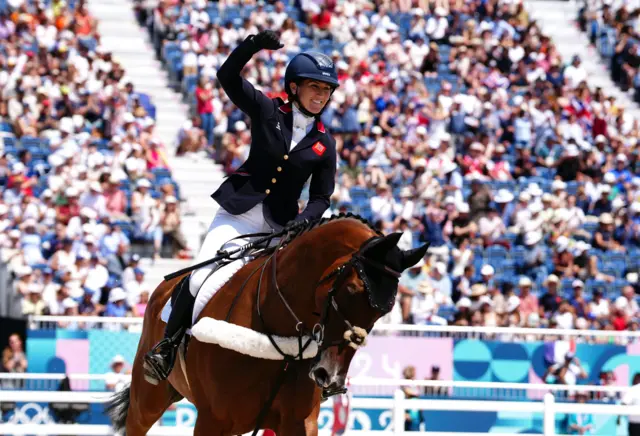 Laura Collett celebrates after Great Britain win gold in team eventing