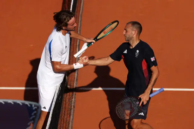 Evans shakes hands with Tsitsipas after losing their match