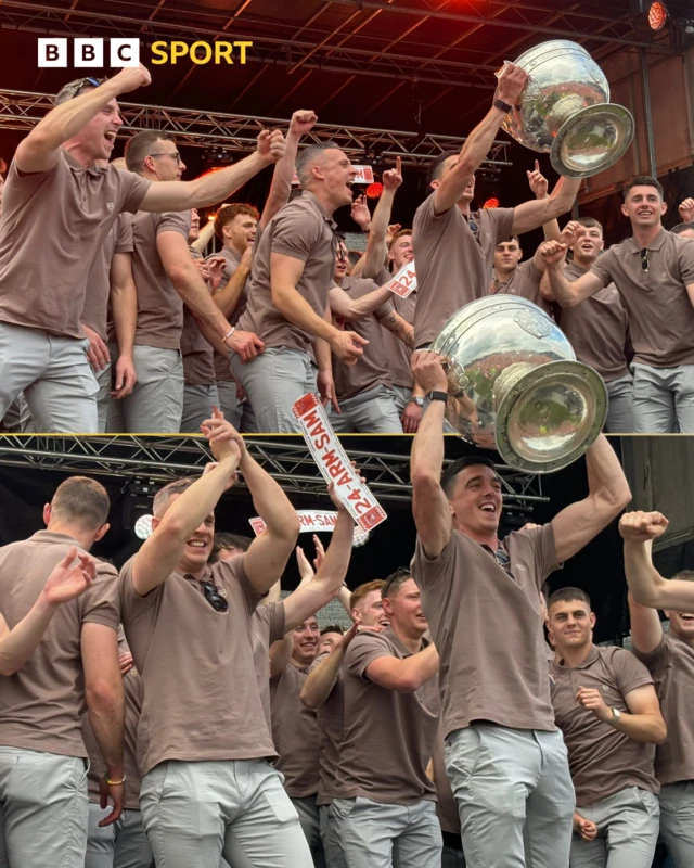 The players celebrate on stage with the Sam Maguire