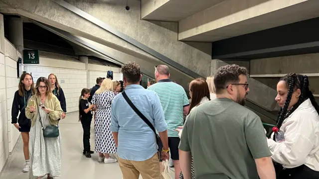 People queuing in the Court One concourse