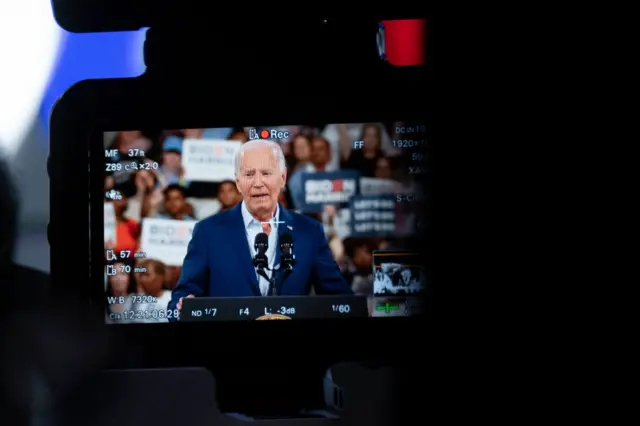 Joe Biden seen through lens of camera