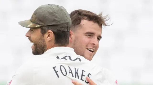 Tom Lawes and Ben Foakes celebrate combining for two wickets in two balls