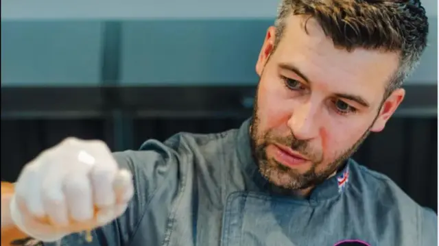 A team chef prepares food