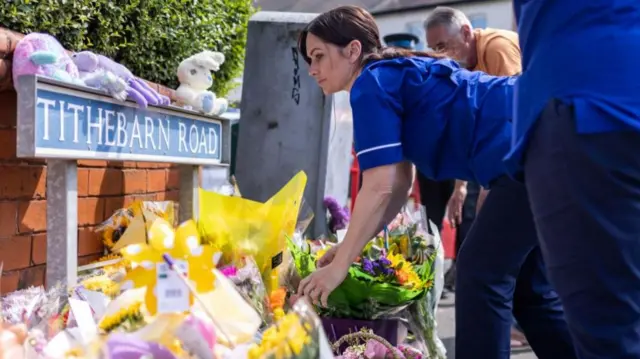 People leaving tributes in Southport earlier