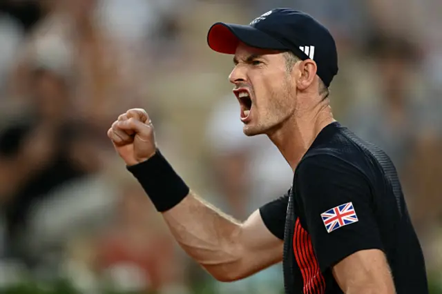 Andy Murray playing with Britain's Daniel Evans reacts