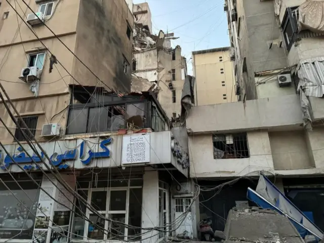 A high-rise building with significant damage to some flats and scorch marks on the walls