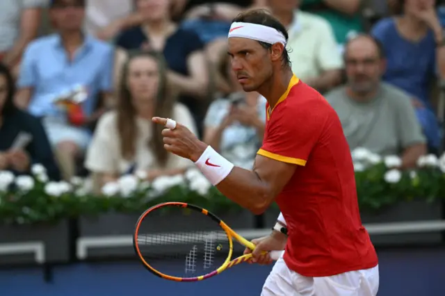 Nadal points with determination after winning a key point