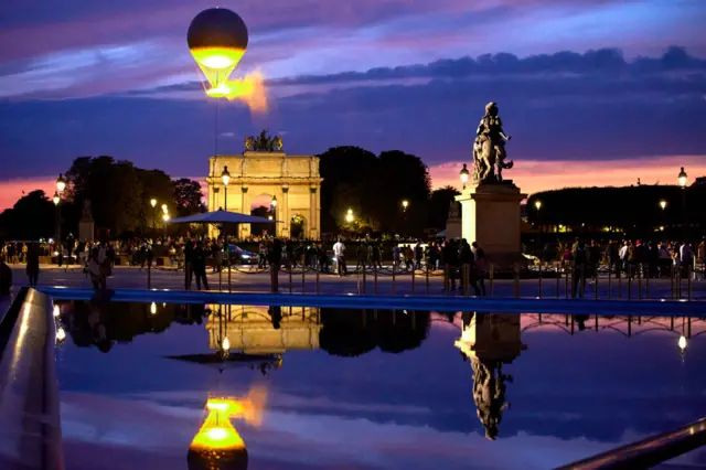 Olympic flame above in the Paris skyline