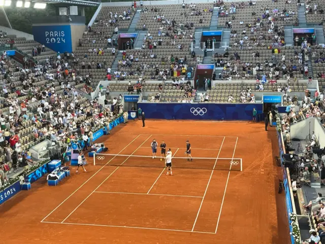 Andy Murray and Dan Evans stroll on to court