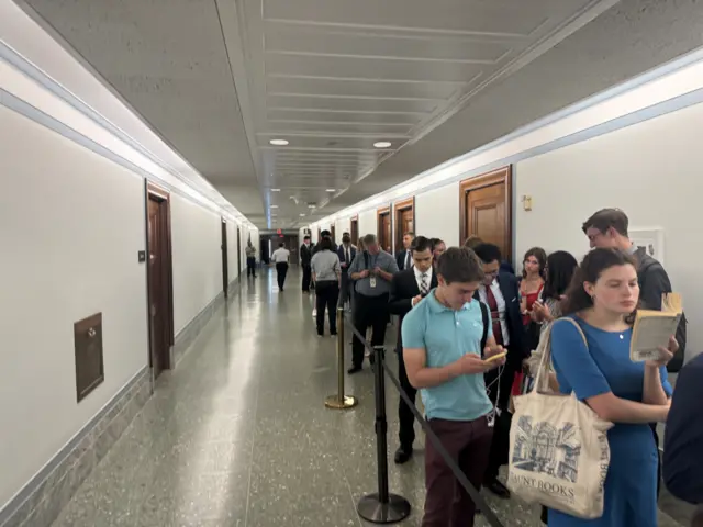 People wait in line for Senate hearing