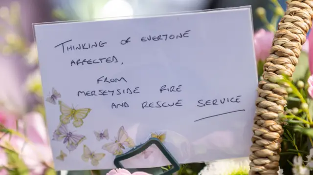 Handwritten note reading 'Thinking of everyone affected, from Merseyside Fire and Rescue Service'