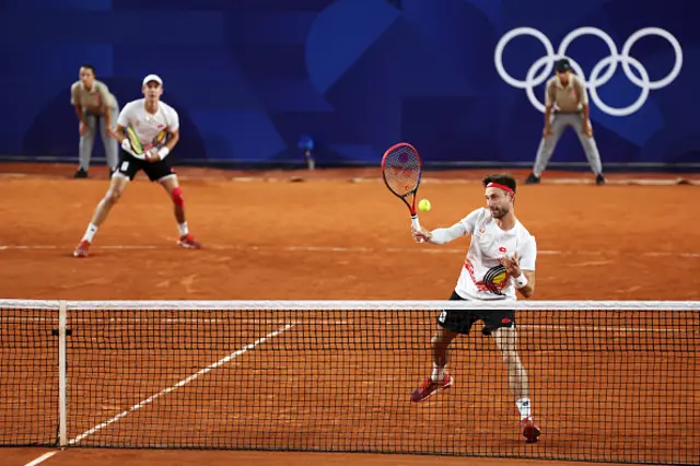 Sander Gille of Team Belgium plays a forehand with partner Vliegen Joran