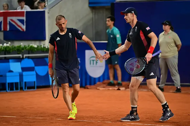 Andy Murray (R) interacts with Britain's Daniel Evans