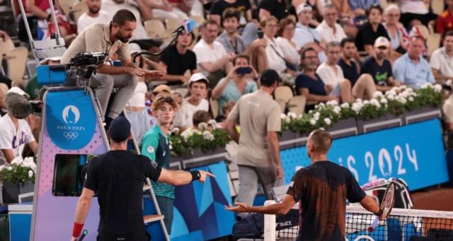 Andy Murray of Britain and Daniel Evans of Britain talk with chair umpire