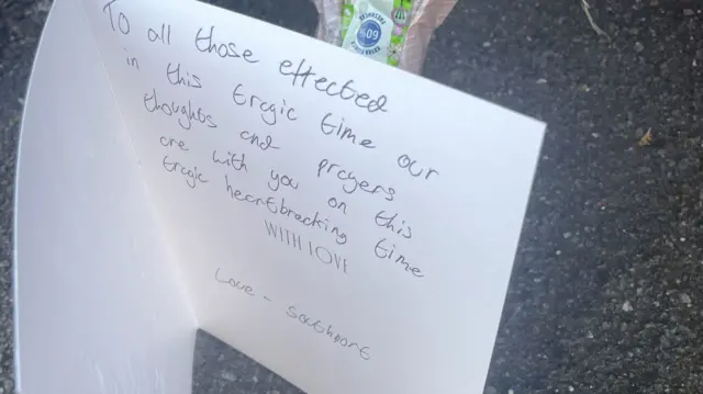 A card left at the scene reads: To all those affected in this tragic time, our thoughts and prayers are with you... love - Southport