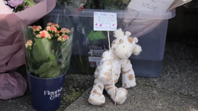 A teddy holding a handwritten note