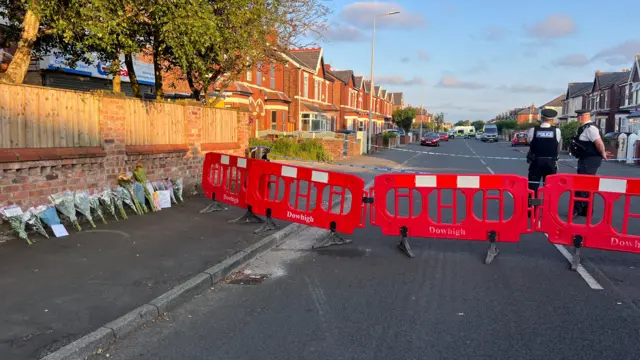 police cordon and flowers