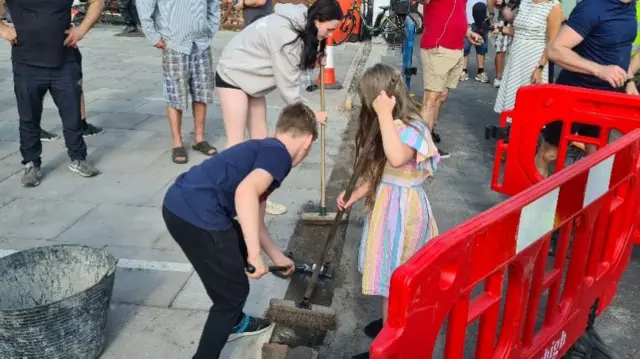 Children cleaning streets