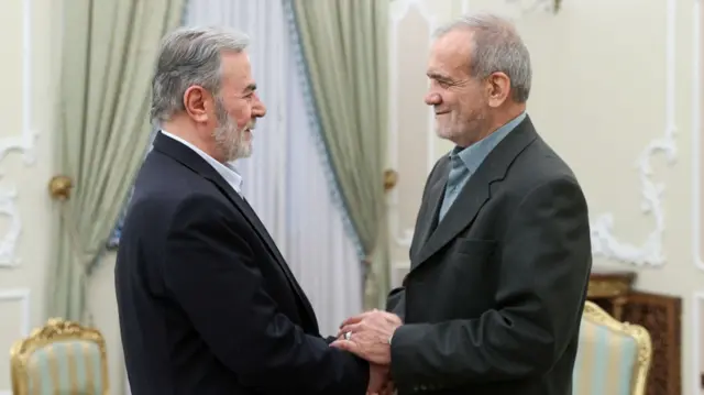 Haniyeh and Pezeshkian shake hands