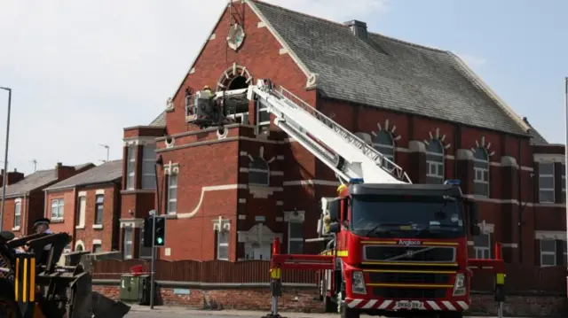 Landscape shot of a fire engine outside the mosque