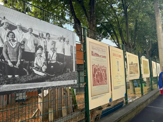 Signs on fences showing history of Yves-du-Manoir stadium