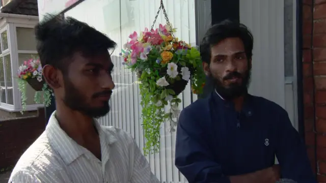 Southport residents Imadur Rahman and Sadik Khan stand outside the front of the house