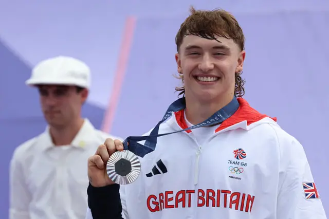 Kieran Reilly smiles with his silver medal