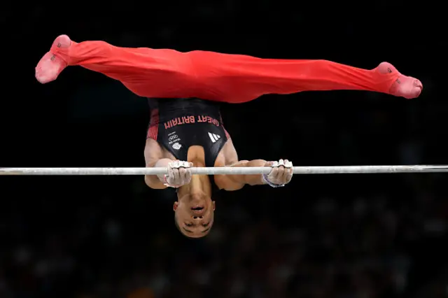 Joe Fraser of Team Great Britain competes on the high bar