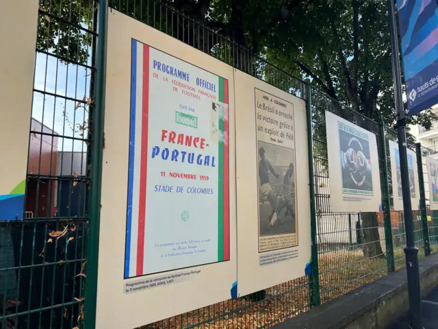 Signs on fences showing history of Yves-du-Manoir stadium