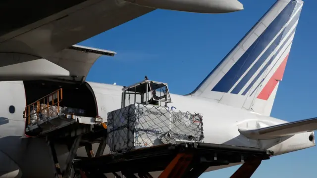 Air France employees load a Boeing 777 at Charles de Gaulle airport in November 2020