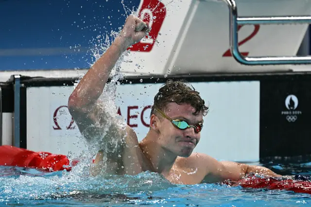 Leon Marchand celebrates