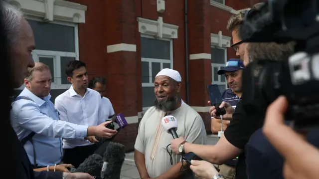 Chairman of the Southport Mosque Ibrahim Hussein speaks to the media