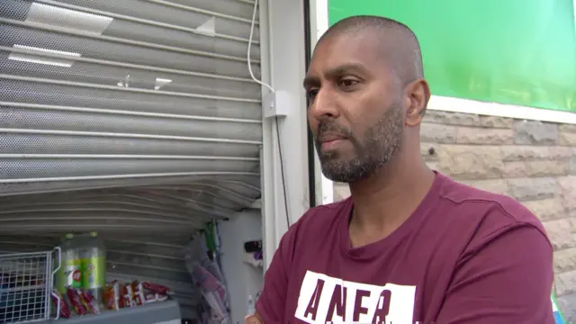 Shopkeeper Chanaka Balasuryla whose store was looted during last night's riots